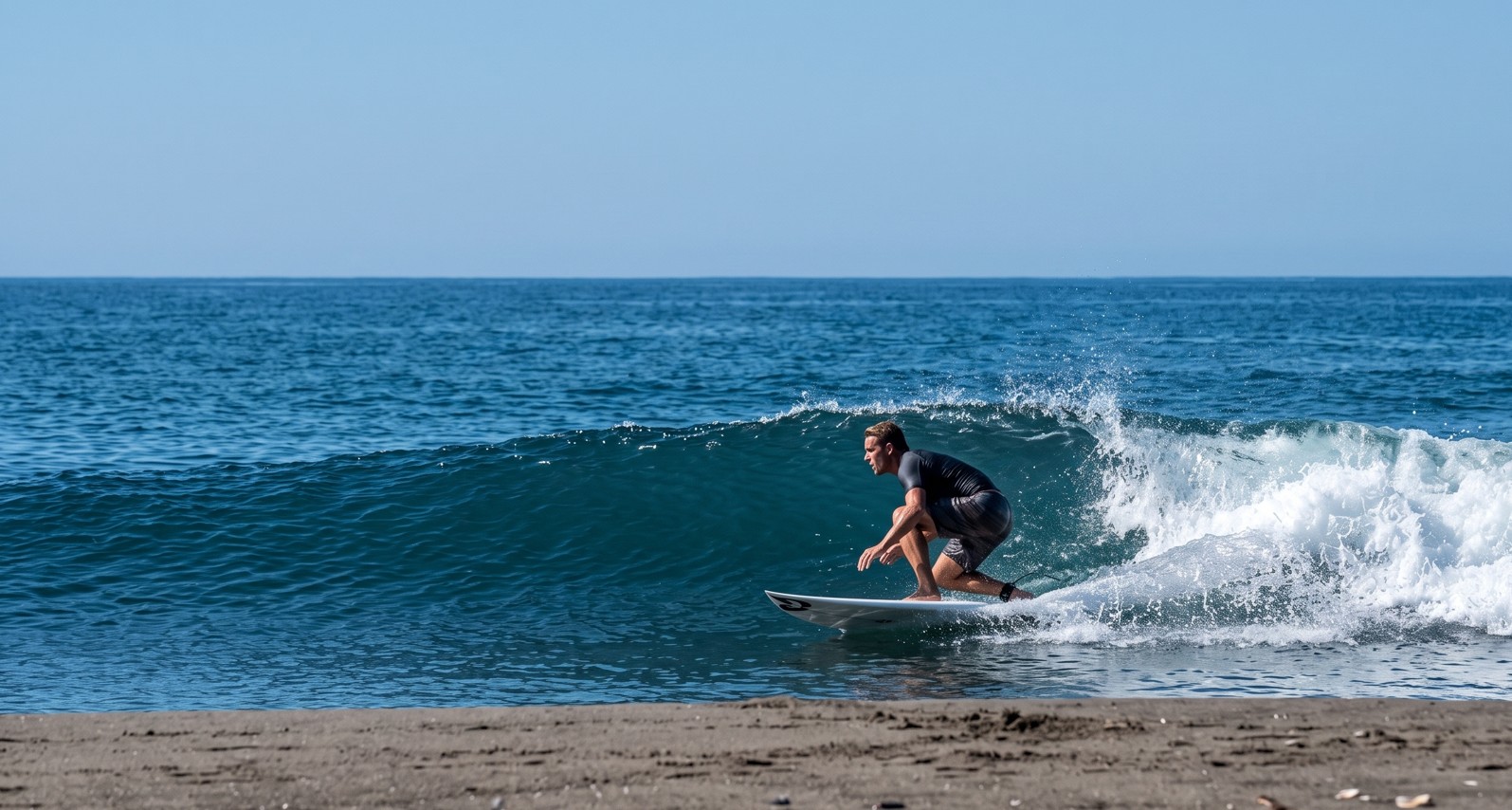 A surfer riding a clean wave at Playa Roca